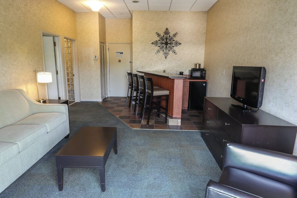Suite, 1 King Bed (Alpine) | Living area | 26-inch TV with cable channels