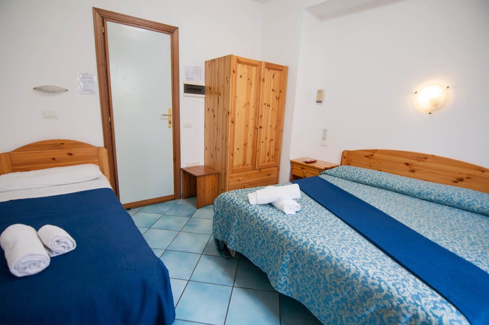 Triple Room, Non Smoking | Desk, blackout drapes, free WiFi, bed sheets
