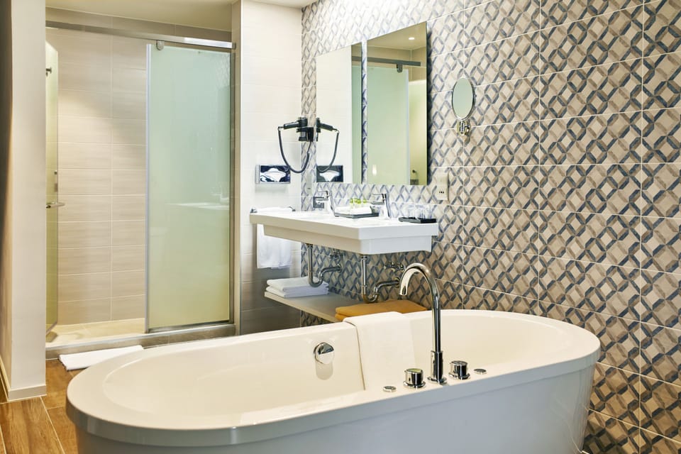 Designer toiletries, hair dryer, slippers, towels