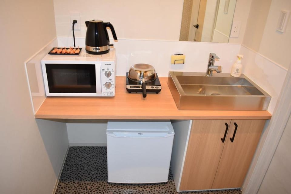 Fridge, microwave, electric kettle, cookware/dishes/utensils