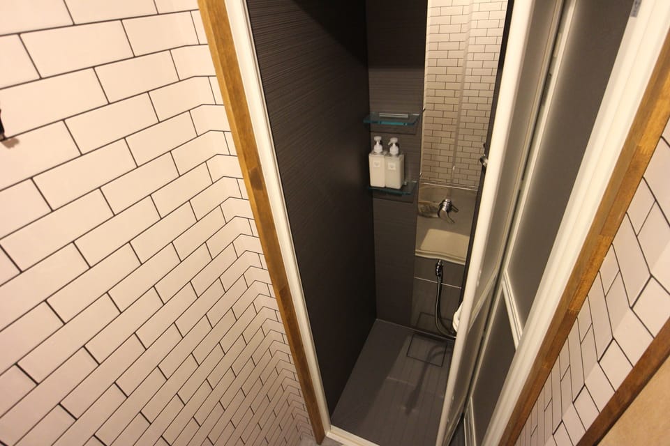 Shower, hair dryer, slippers, towels