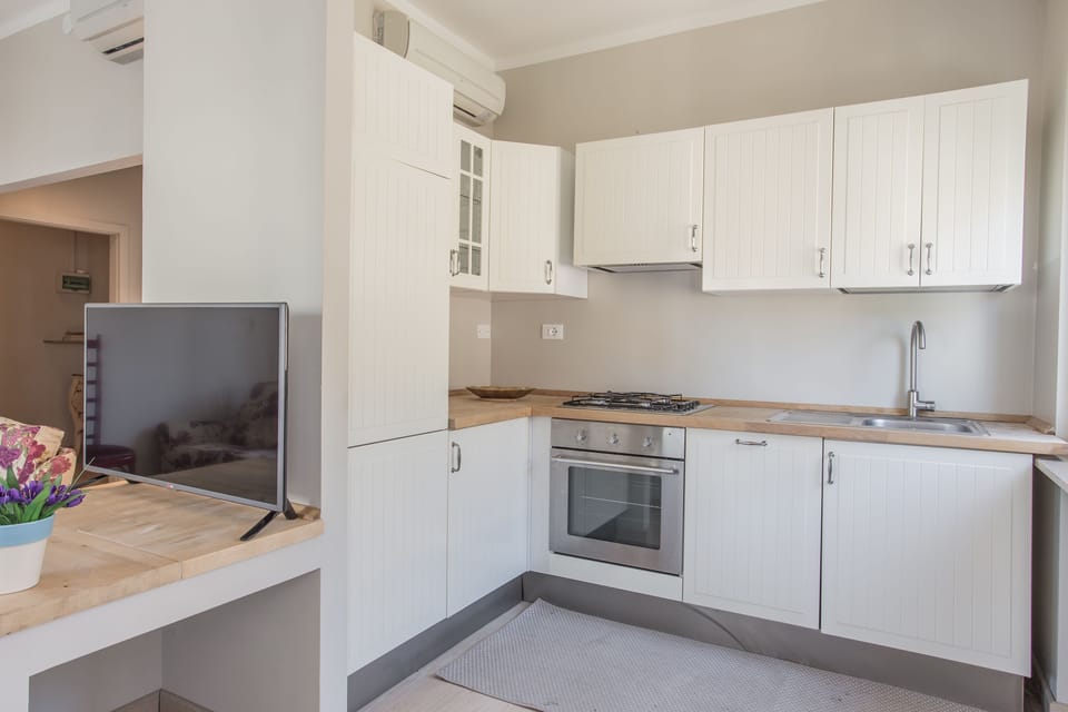 Apartment, 2 Bedrooms | Private kitchen | Full-size fridge, stovetop, cookware/dishes/utensils