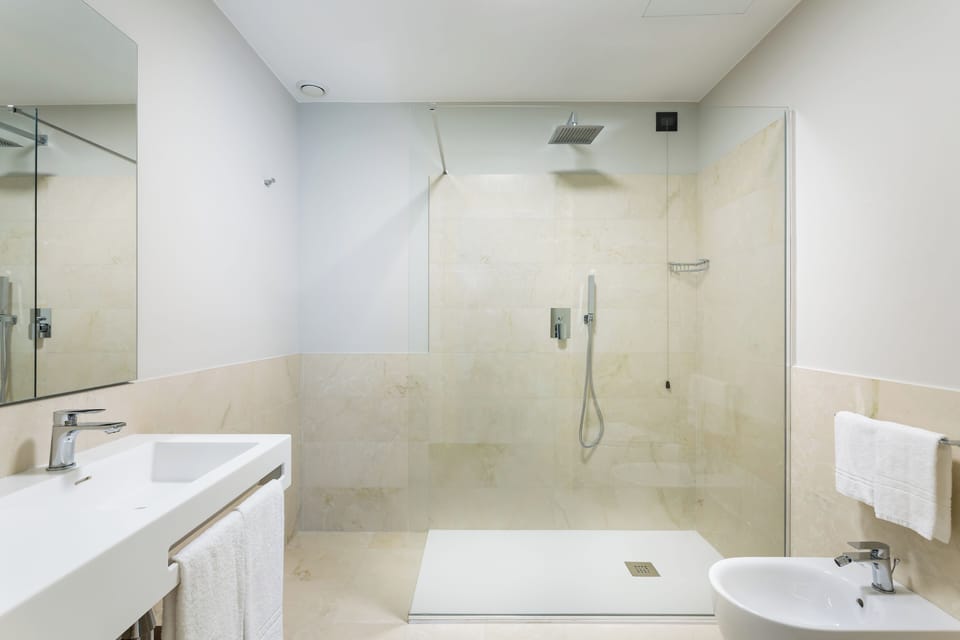 Superior Room | Bathroom | Rainfall showerhead, free toiletries, hair dryer, slippers