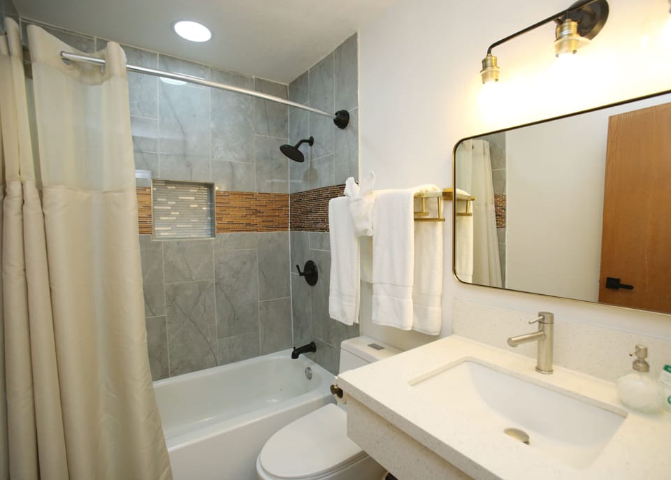 Deluxe (Non-Pet) Double Queen Room | Bathroom | Hydromassage showerhead, hair dryer, bathrobes, towels