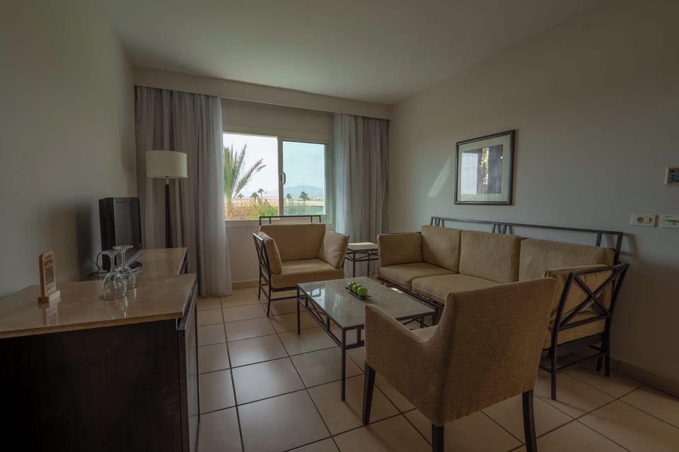 Family, Queen Bed, Garden View | Living room | 26-inch TV with satellite channels