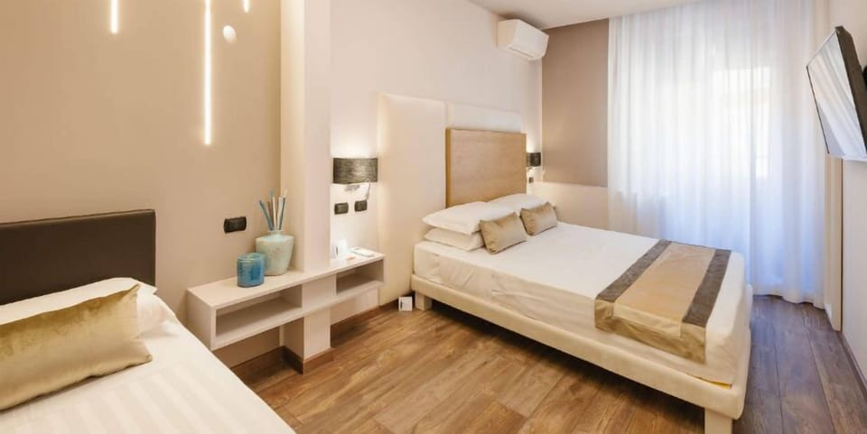 Deluxe Triple Room | Minibar, in-room safe, individually decorated, individually furnished