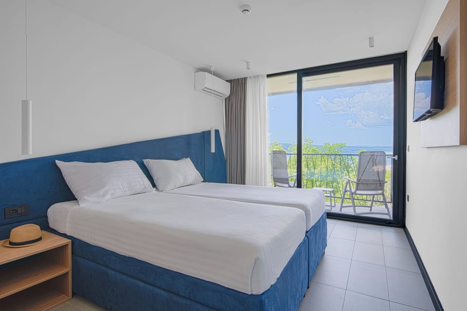 Double Room with extra pull-out bed, Sea Side, Balcony | In-room safe, desk, free WiFi, bed sheets