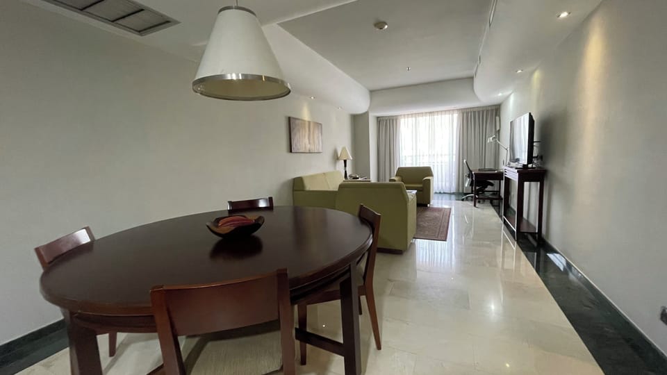 Deluxe Suite, Balcony, City View | Living area | TV