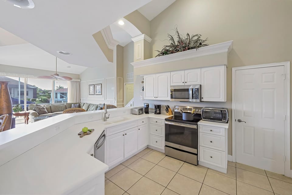 House, Multiple Beds (Large waterfront home with all-day su) | Private kitchen | Fridge, microwave, oven, stovetop
