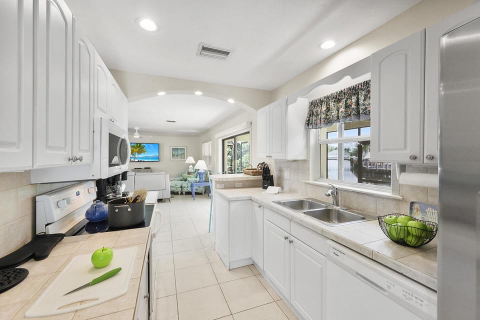 House, Multiple Beds (Pet-friendly waterside home with pool) | Private kitchen | Fridge, microwave, oven, stovetop