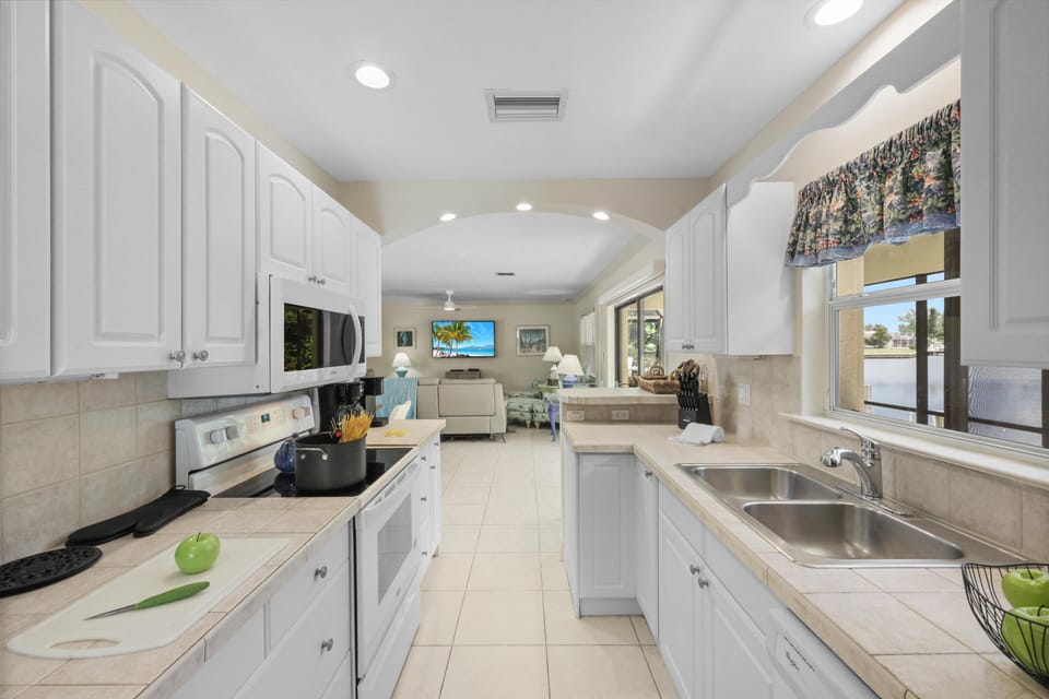 House, Multiple Beds (Pet-friendly waterside home with pool) | Private kitchen | Fridge, microwave, oven, stovetop