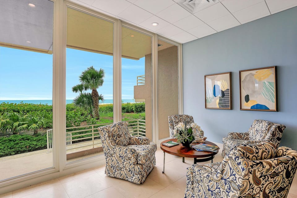 Condo, Multiple Beds (Beachfront condo with 180-degree view) | Living room | Flat-screen TV