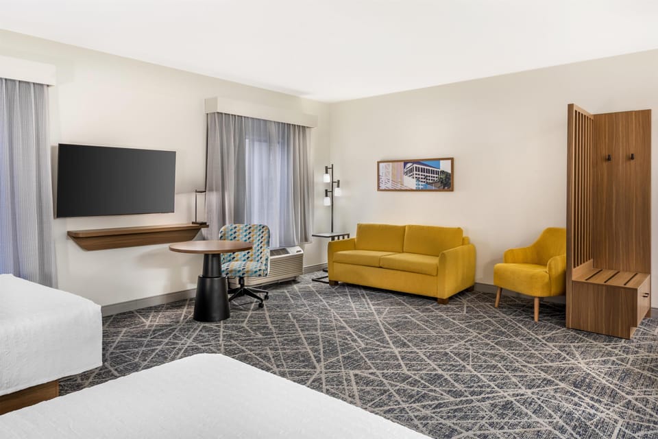 Studio Suite, 2 Queen Beds, Refrigerator & Microwave | Living area | 32-inch LCD TV with satellite channels, TV