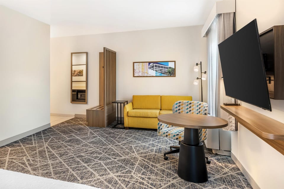 Studio Suite, 1 King Bed, Refrigerator & Microwave | Living area | 32-inch LCD TV with satellite channels, TV
