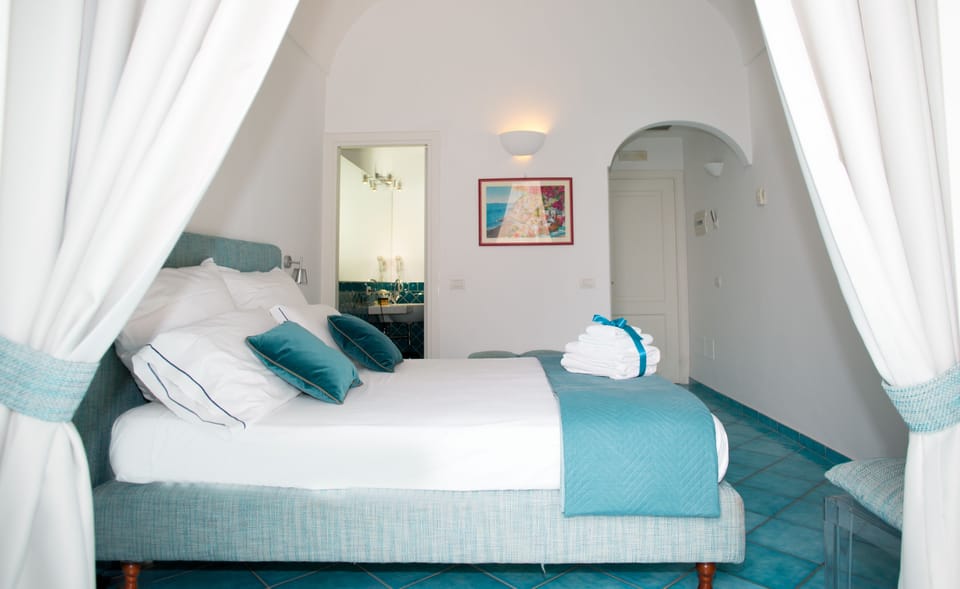Superior Double Room, Terrace, Partial Sea View | Minibar, in-room safe, individually decorated, desk