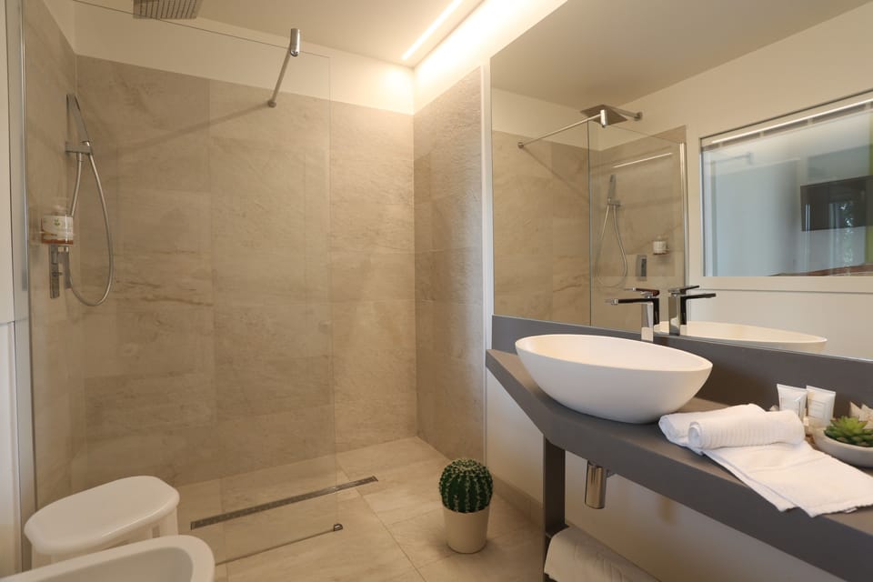 Deluxe Double Room, Balcony, Partial Sea View | Bathroom | Shower, rainfall showerhead, hair dryer, bidet
