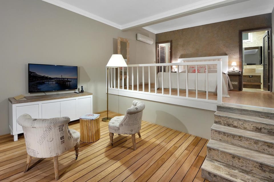 Romantic Suite, 1 Queen Bed, Pool Access, Sea View | Living area | 65-inch LCD TV with satellite channels, TV