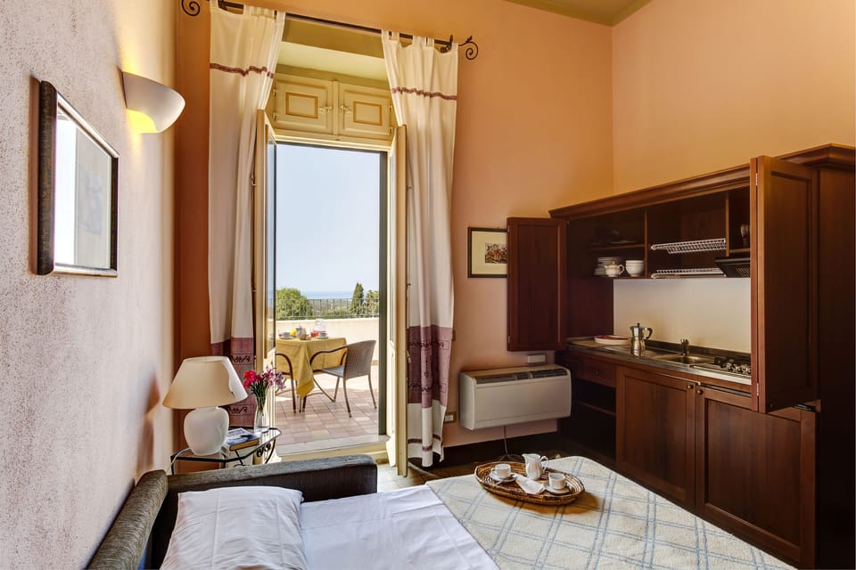 Suite, Garden View | Private kitchen | Fridge, highchair