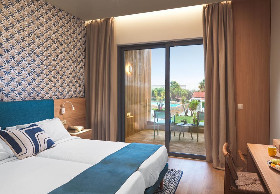 Premium Room Pool View | Minibar, in-room safe, desk, laptop workspace