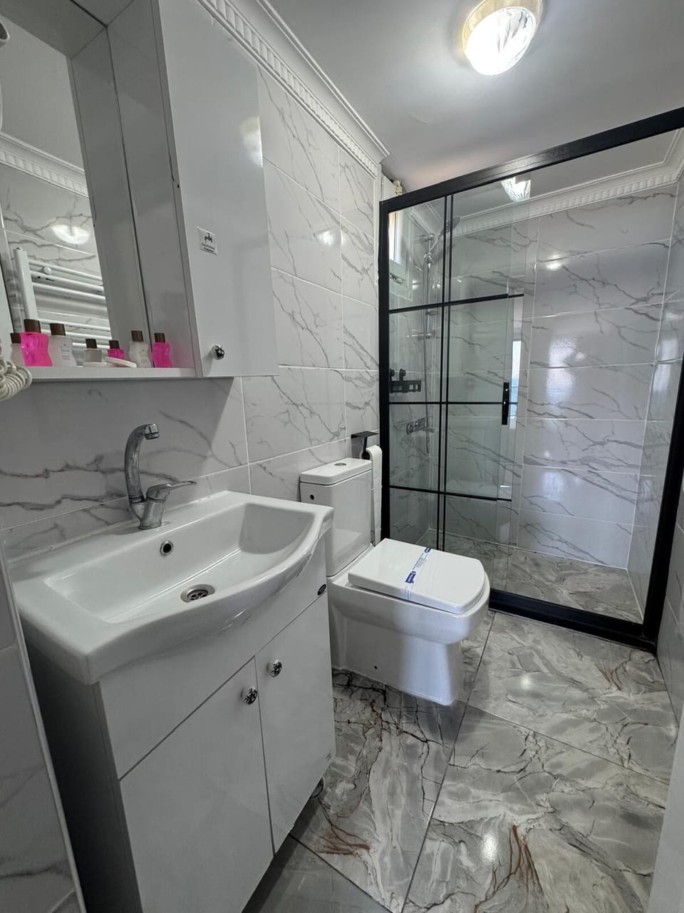 Shower, hair dryer, slippers, towels