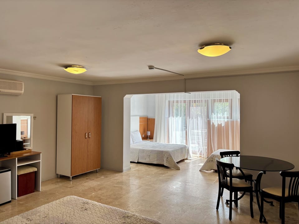 Economy Quadruple Room, 1 Bedroom | Minibar, desk, laptop workspace, blackout drapes