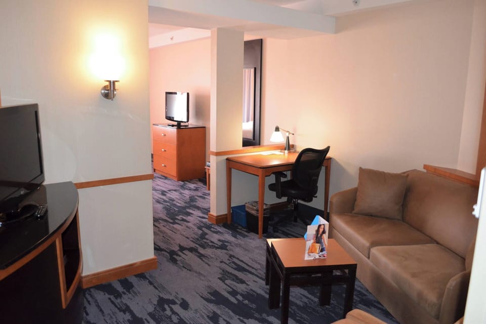 Suite, Multiple Beds | Living room | 35-inch flat-screen TV with cable channels, TV