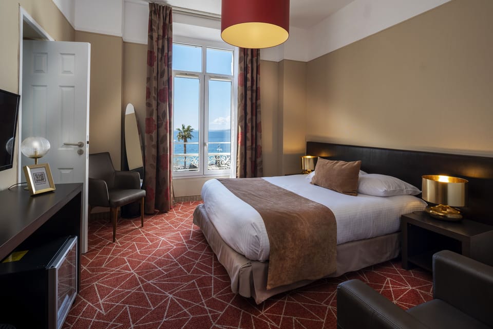 Double or Twin Room, Sea View | Minibar, in-room safe, desk, blackout drapes