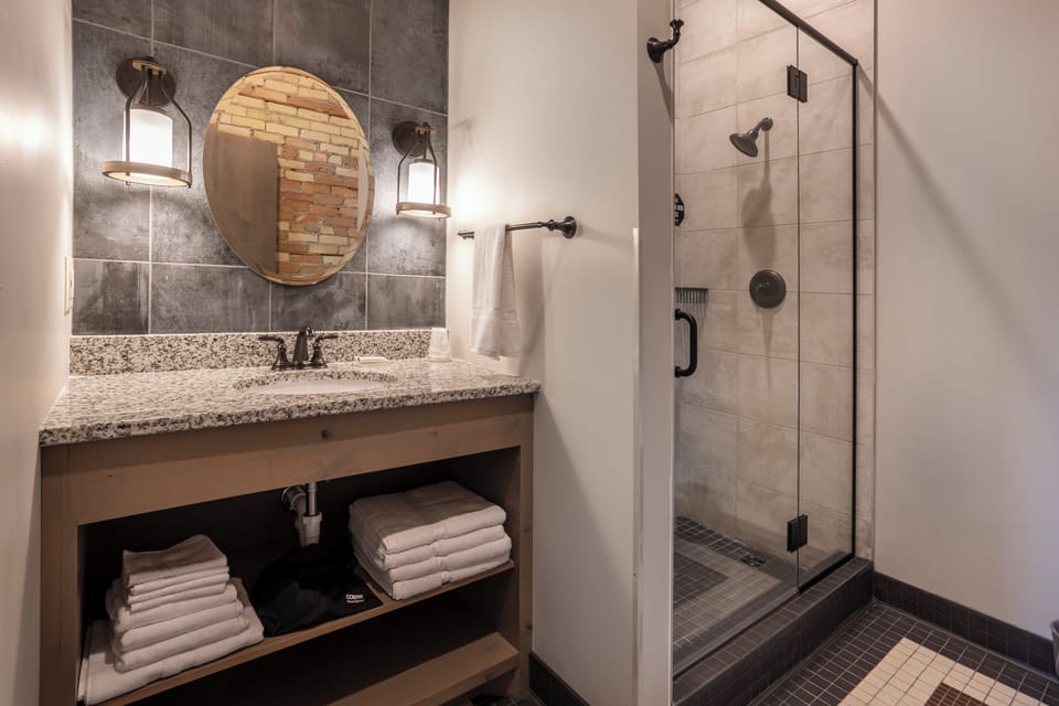 Room 15 @ 102 West Main Street | Bathroom | Shower, hair dryer, towels
