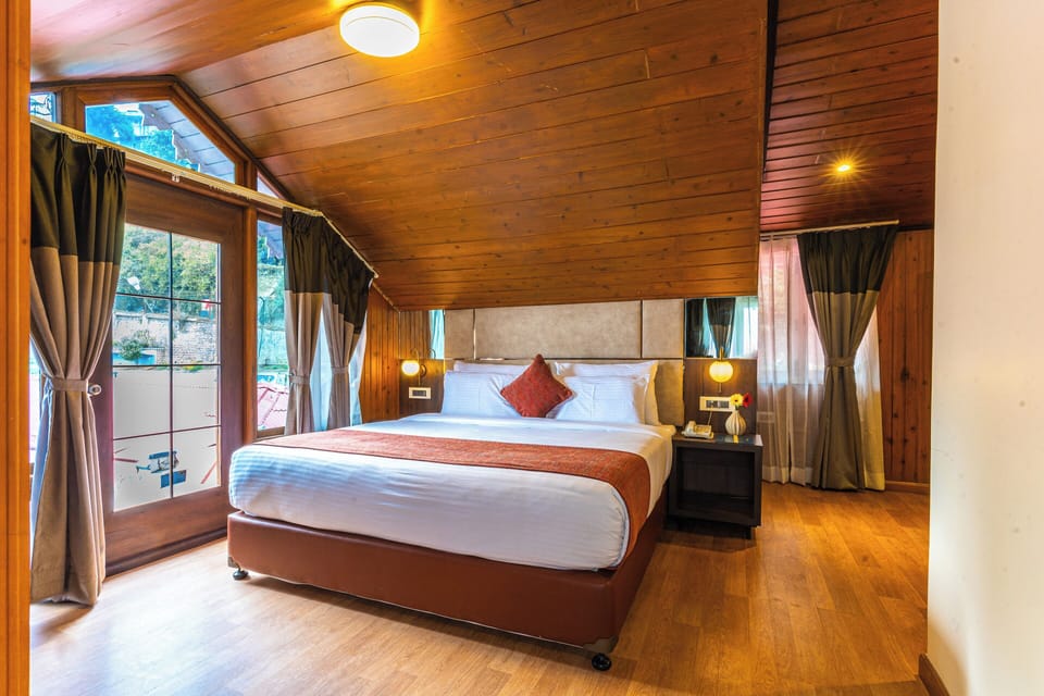 Attic View Room with Balcony | Living area | 102-inch flat-screen TV with digital channels