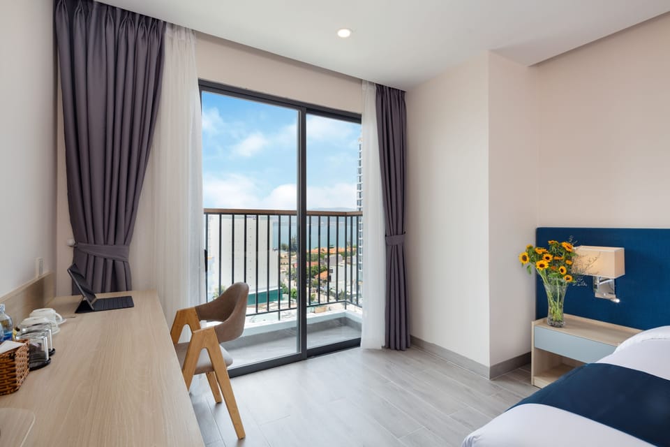 Deluxe Room, Balcony, Sea View | Minibar, in-room safe, desk, free WiFi