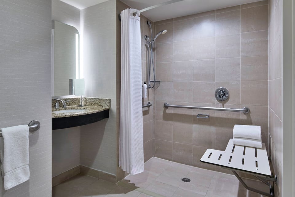 Combined shower/tub, designer toiletries, hair dryer, towels