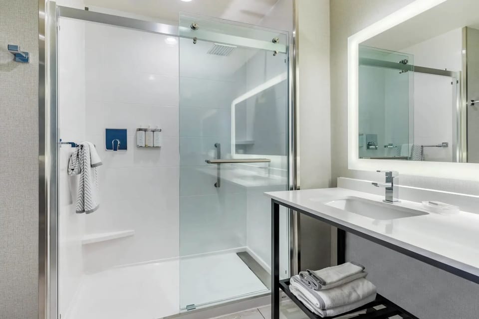 Rainfall showerhead, designer toiletries, hair dryer, towels