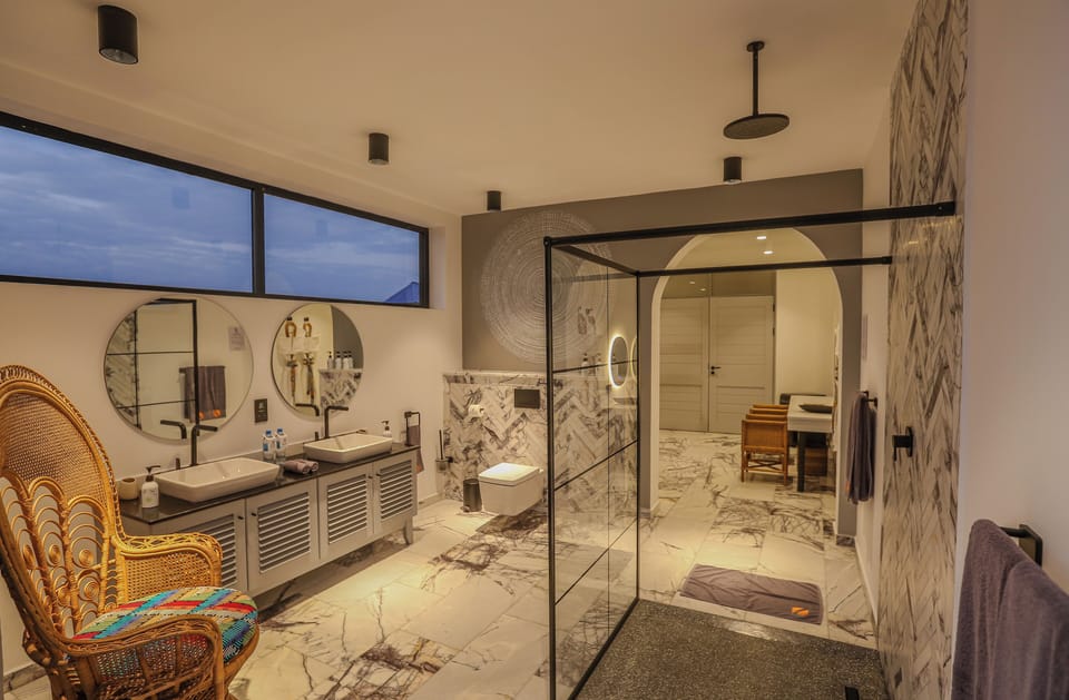 Shower, designer toiletries, hair dryer, bathrobes