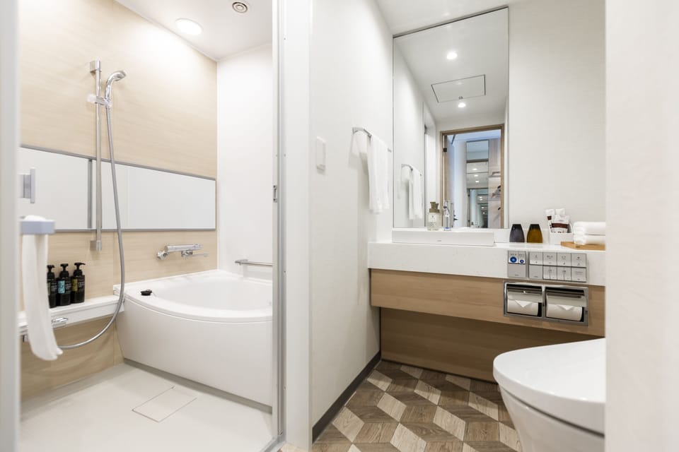 Deluxe Twin Room | Bathroom | Eco-friendly toiletries, hair dryer, slippers, electronic bidet
