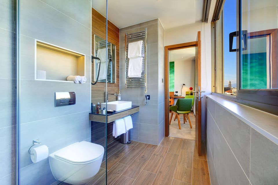 Deluxe Double or Twin Room, City View | Bathroom | Hair dryer, slippers, towels, soap