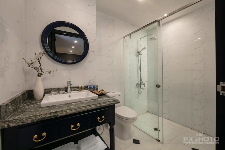 Executive Twin | Bathroom | Rainfall showerhead, designer toiletries, hair dryer, slippers