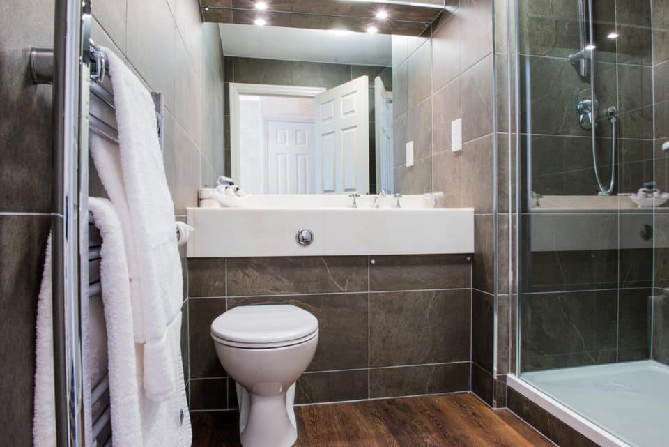 Shower, designer toiletries, hair dryer, towels