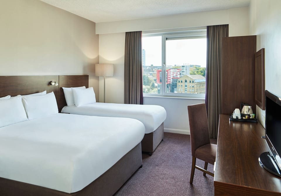 Hypo-allergenic bedding, desk, laptop workspace, blackout drapes