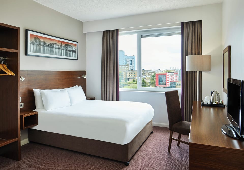 Hypo-allergenic bedding, desk, laptop workspace, blackout drapes