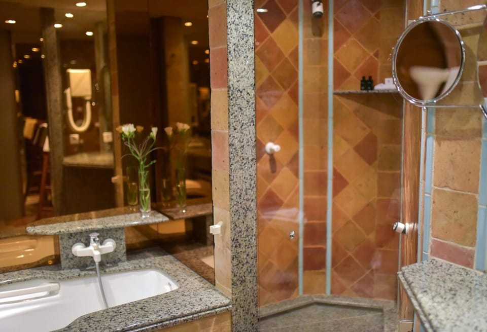 Signature Suite, Balcony | Bathroom | Separate tub and shower, rainfall showerhead, free toiletries