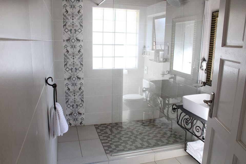 Shower, rainfall showerhead, designer toiletries, towels