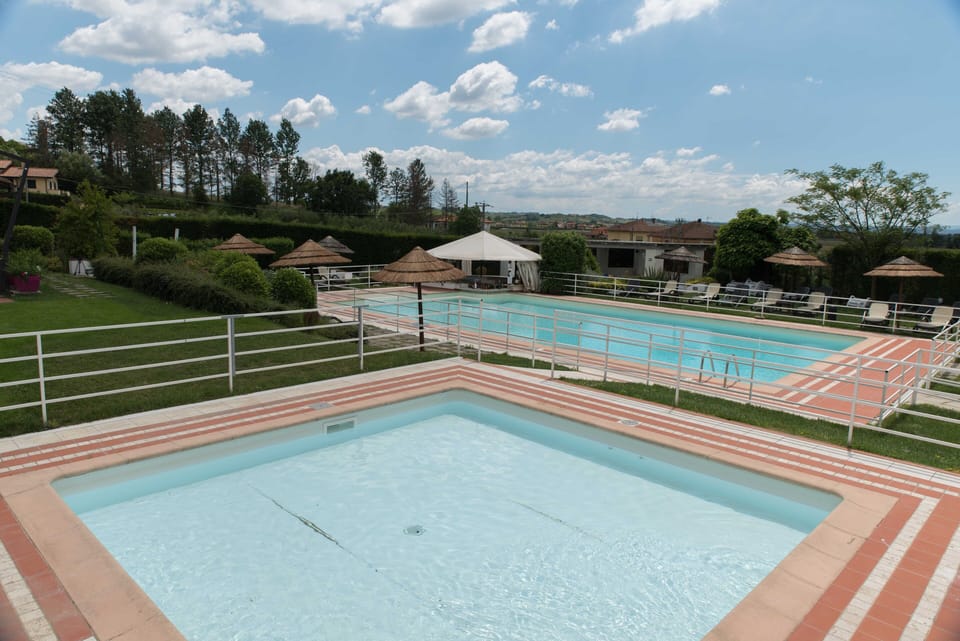 Seasonal outdoor pool, open 10:00 AM to 7:00 PM, pool umbrellas