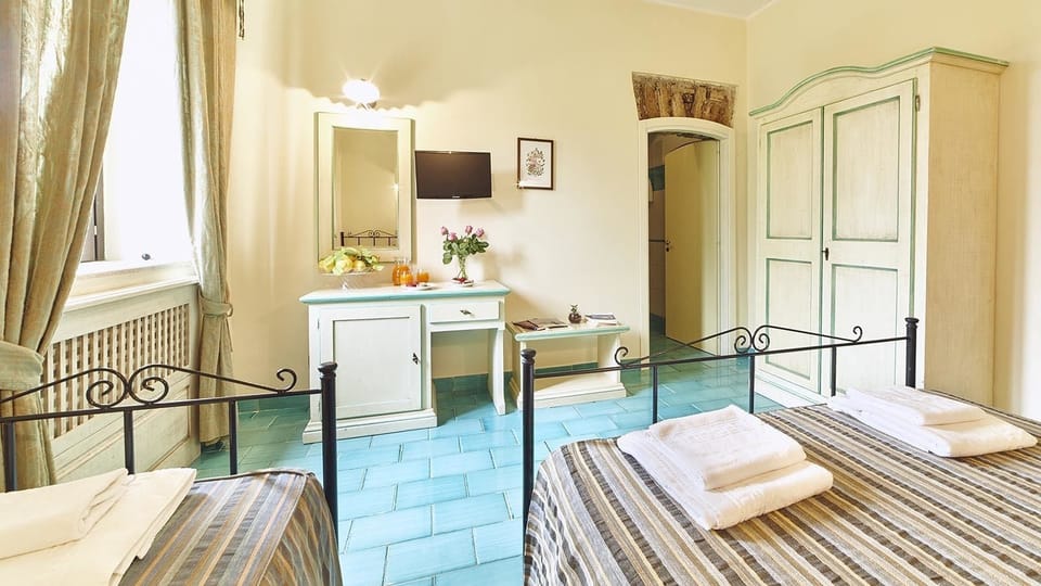 Family Room, Garden View | Desk, laptop workspace, free WiFi, bed sheets