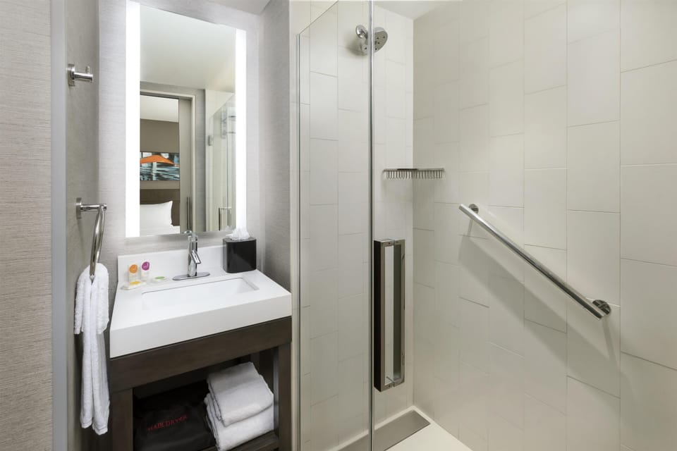 Shower, designer toiletries, hair dryer, towels