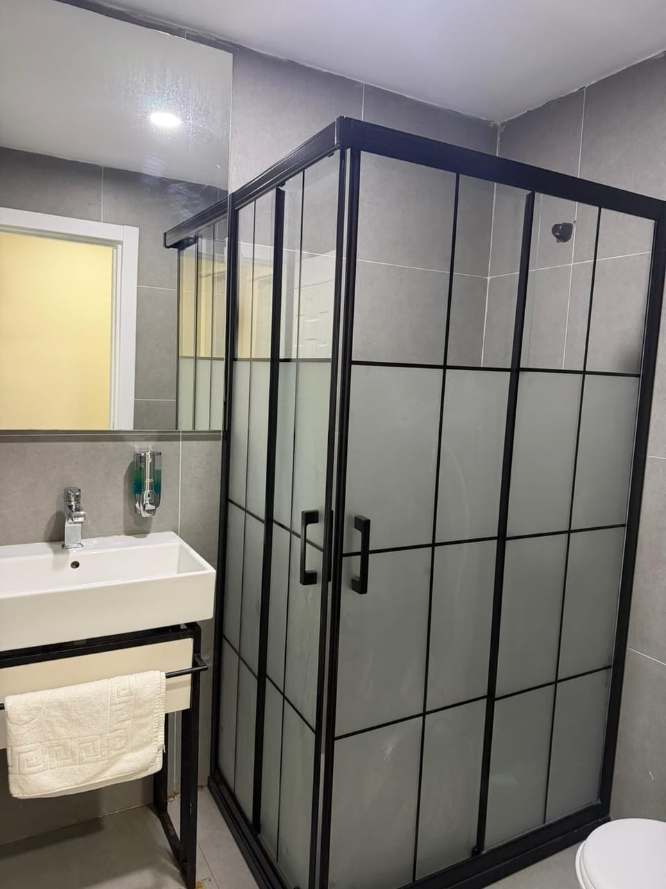Shower, hair dryer, slippers, towels