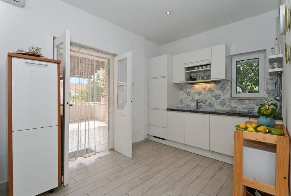 Apartment (A2) | Private kitchen | Fridge, microwave, stovetop, dishwasher