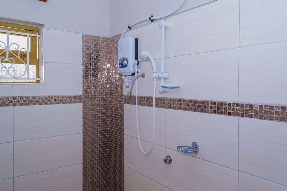 Shower, rainfall showerhead, slippers, towels