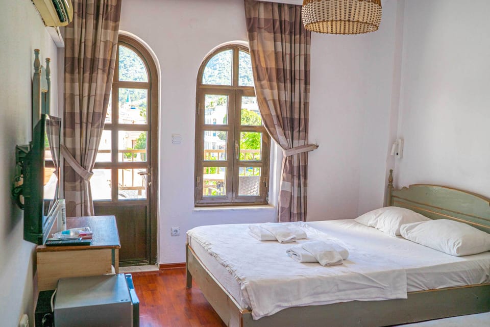 Standard Triple Room, Mountain View, Beachfront | Blackout drapes, soundproofing, iron/ironing board, free WiFi