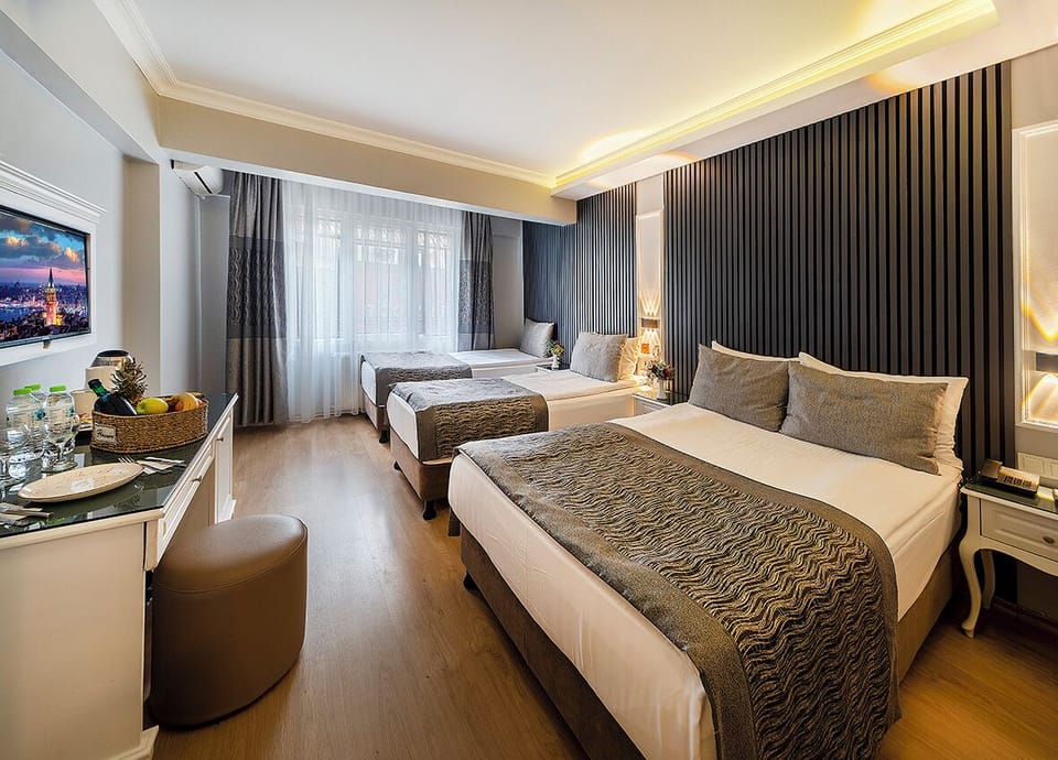 Economy Triple Room, Courtyard View | Premium bedding, minibar, in-room safe, laptop workspace