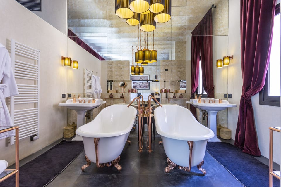 Grand Suite | Bathroom | Deep soaking tub, rainfall showerhead, designer toiletries, hair dryer